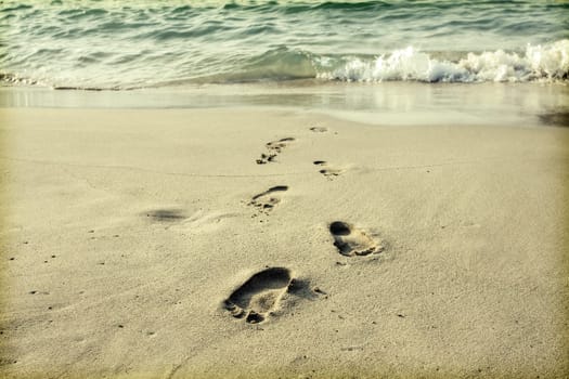 Footsteps in the sand on the beach