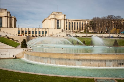 Park in Paris near the Eiffel Tower with a fountain on a sunny day