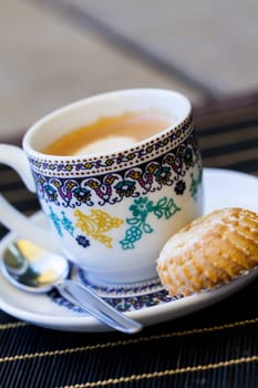 Cup with fresh coffee espresso coffee spoon and pastries as close-up
