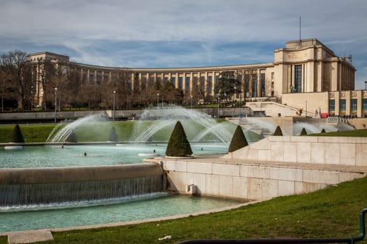 Park in Paris near the Eiffel Tower with a fountain on a sunny day