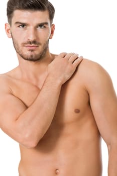 attractive muscular young man with free torso and beard isolated against white background