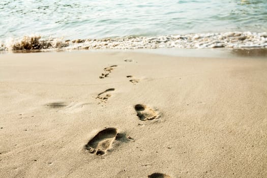 Footsteps in the sand on the beach