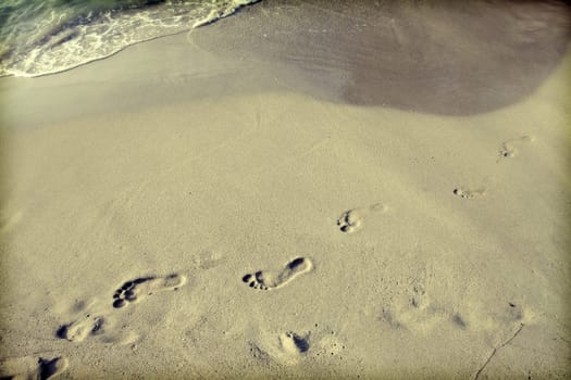 Footsteps in the sand on the beach