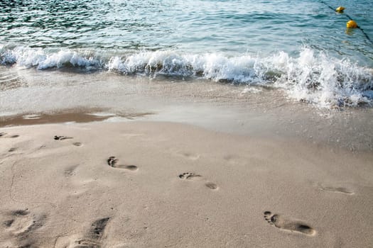 Footsteps in the sand on the beach