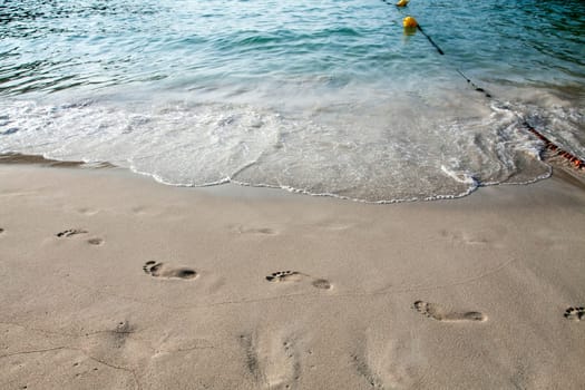 Footsteps in the sand on the beach