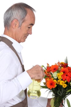 Man spraying flowers
