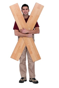 Carpenter with floorboards