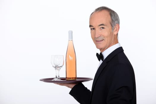 Waiter carrying wine on tray