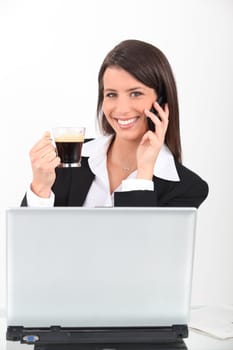 Businesswoman with coffee and mobile telephone