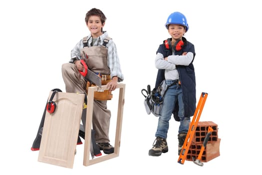 Two children acting out adult trades - carpentry and construction