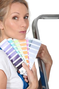 Woman holding paint swatches