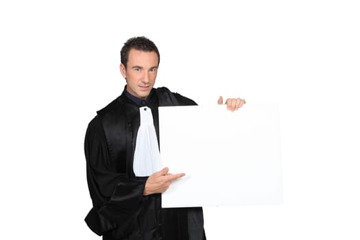 Man dressed in judge costume holding white card board square