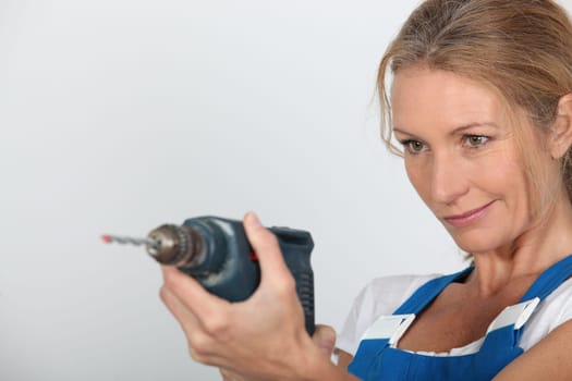 Women holding electric drill