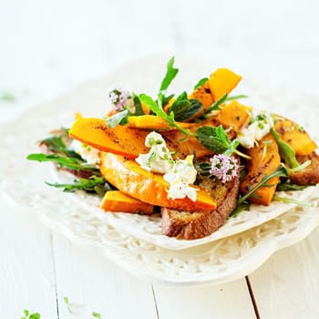 Gourmet Fresh Modern Summer Salad with Pumpkin Roasted Served on Table .
