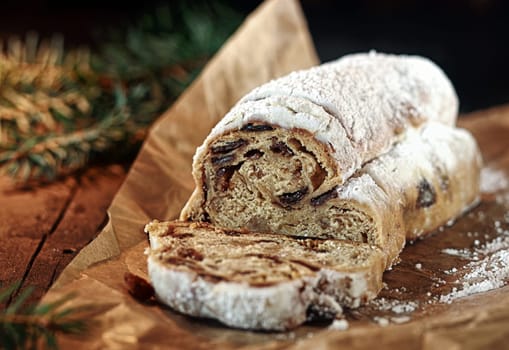 Spicy sweet Christmas bread with raisins and candied fruit topped with powdered sugar for a traditional snack over the festive season