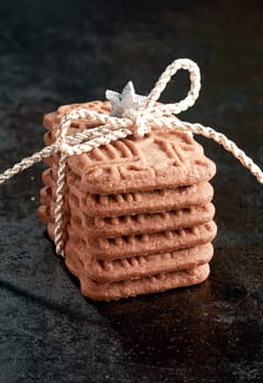 Stack of speciality speculoos biscuits, a spicy crunchy Dutch biscuit served for the feast of St Nicholas, and now enjoyed as a Christmas treat in many countries tied with string as a gift