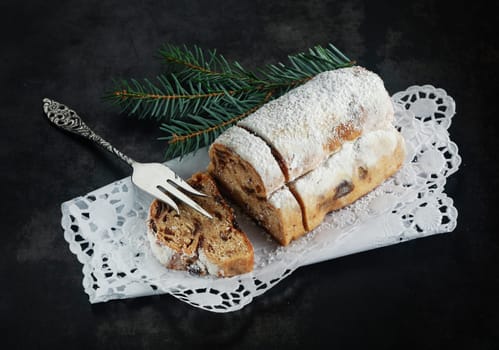 Christmas fare with a high angle view of a loaf of panettone bread, a speciality sweet bread made with spices and topped with powdered sugar for the festive season