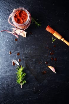 Cayenne Marinade Meat Powder and Brush on Dark Gray Table.