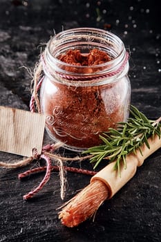 Close Up Brush and Cayenne Marinade Powder Container for Meat on Table