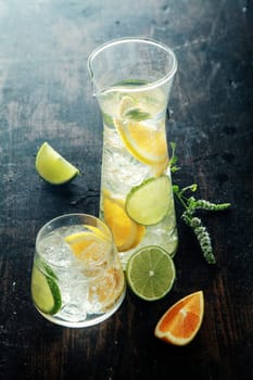 Mouthwatering Lemon Water with Fresh Lemon Inside on Wooden Table. Good Source for Vitamin C.