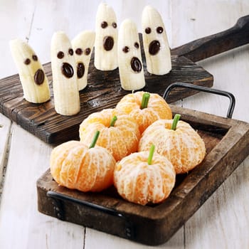 Healthy Halloween Treats Made into Banana Ghosts and Clementine Orange Pumpkins