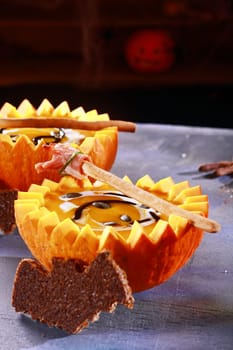Halloween Pumpkin Soup with Bat Shaped Toast Crouton Served in Half Pumpkins