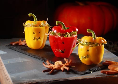 Red and Yellow Peppers with Scary Faces Stuffed with Sprouts with Edible Octopus