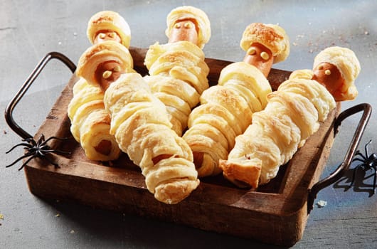Five Weiner Mummies Wrapped in Pastry on Tray for Halloween Party Appetizer