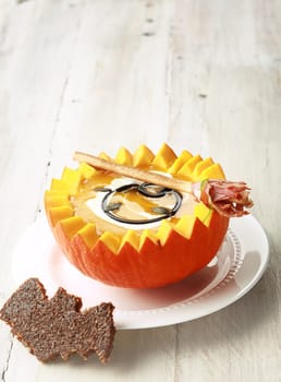 Pumpkin Soup with Bat Shaped Toast Crouton and Broomstick Bread Stick and Copyspace
