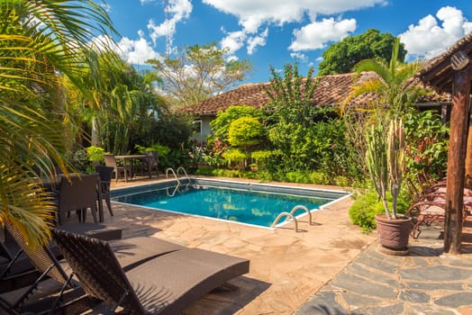 Beautiful swimming pool surrounded by lush green vegetation in Concepcion, Bolivia