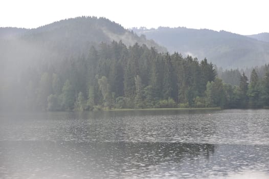 Misty landscapes in Sösestausee,middle mountains in the Harz,Germany Sunbeam through Sösestausee after the rain.