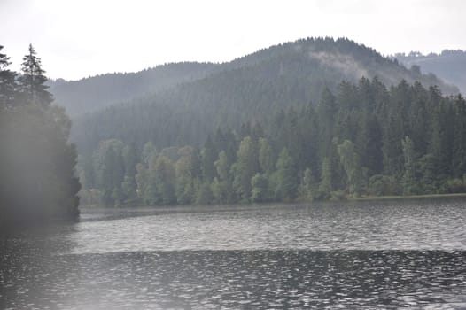 Misty landscapes in Sösestausee,middle mountains in the Harz,Germany Sunbeam through Sösestausee after the rain.