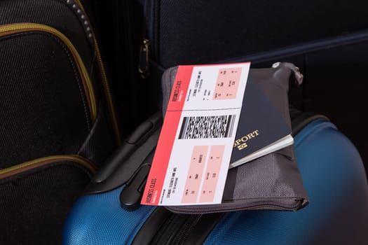 Airline ticket, passport and luggage, ready to travel.