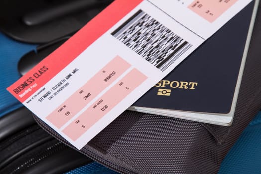 Airline ticket, passport and luggage, ready to travel.