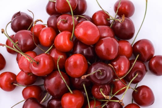 Lots of cherries on white background.
