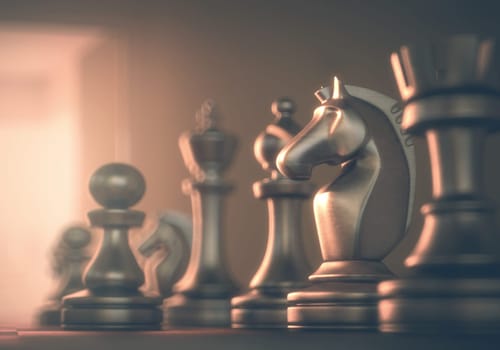 Chessboard with pieces of metal in depth of field view.