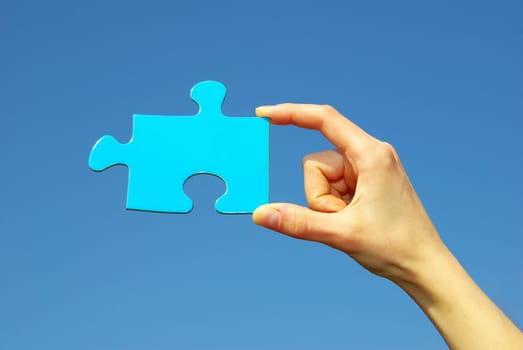 puzzle in hand isolated on sky background