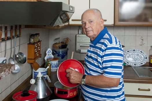 Pensioner in the kitchen while cooking