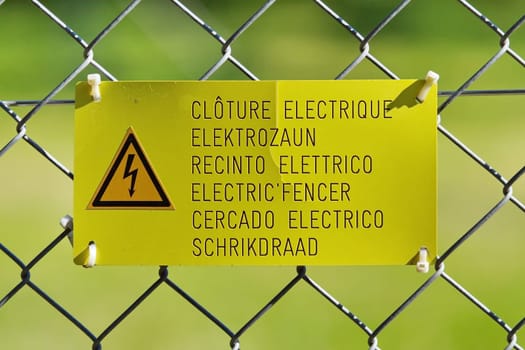 Danger high voltage sign on a fence
