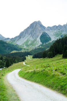 French countryside road with Pennaz Needles in the background