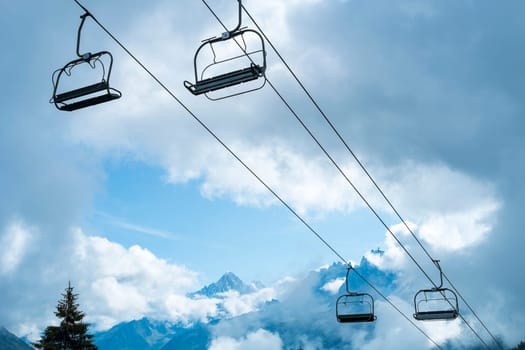 Low angle shot of alpine air lift with trees in the background