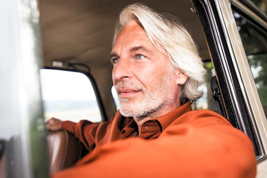 An image of a nice man in his historic car