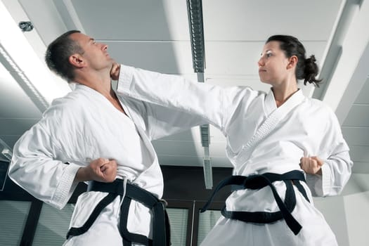 An image of a woman and a man fighting