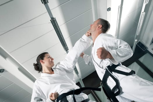 An image of a woman and a man fighting