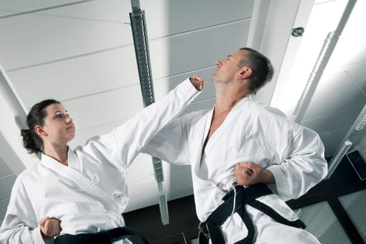 An image of a woman and a man fighting