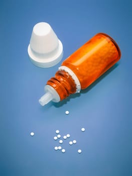 An image of a homeopathic medicine bottle with tablets