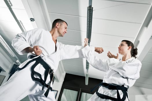 An image of a woman and a man fighting