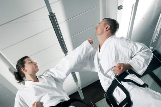 An image of a woman and a man fighting