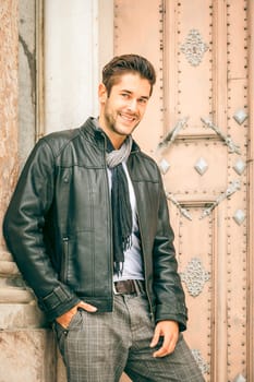An image of a young man with a black leather jacket