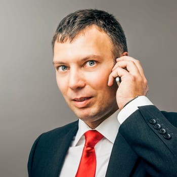 An image of a business man with mobile phone